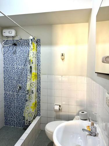 a bathroom with a sink and a shower at La Condamine Apart Hotel in Iquitos