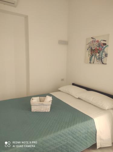 - une chambre avec un lit et un panier dans l'établissement Summer House, à Isola delle Femmine