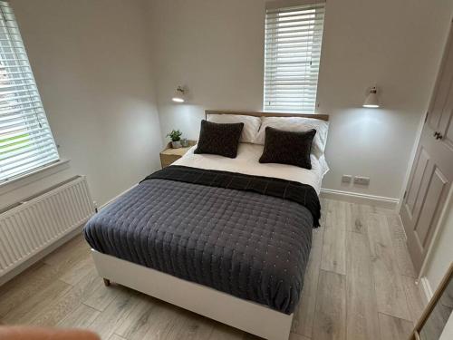 a bedroom with a large bed with pillows on it at Premium executive Apartment in Dunfermline in Dunfermline