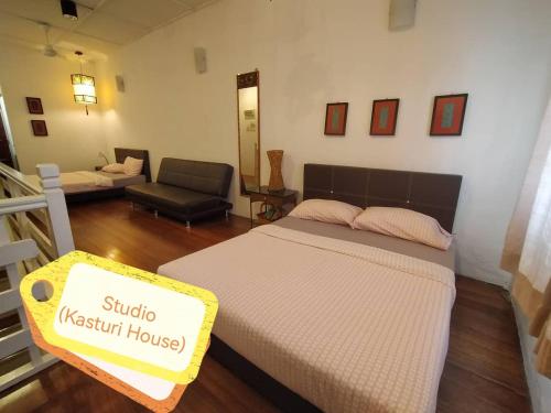 a bedroom with a bed with a sign on it at Malacca Jonkerhouse in Melaka