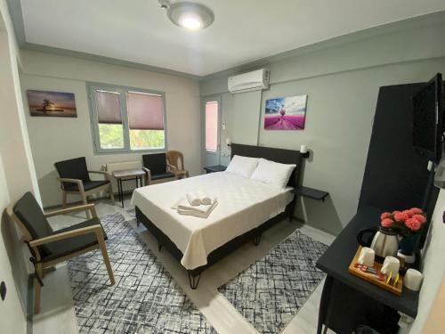 a bedroom with a bed and a table and chairs at Eraliz in Buca