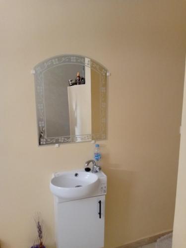 a bathroom with a sink and a mirror at شقة فونتي العليا in Agadir
