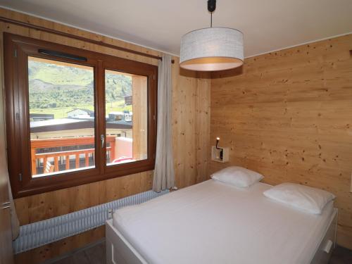 a bedroom with a white bed and a window at Appartement Confort 4 Pers, Balcon Sud, Proche Pistes et Commerces, WIFI Inclus - FR-1-502-406 in Tignes