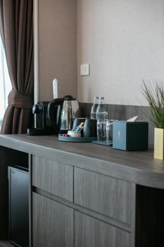 a counter in a hotel room with a counter top at Siam Mandarina Hotel - Free BKK Airport Shuttle in Lat Krabang