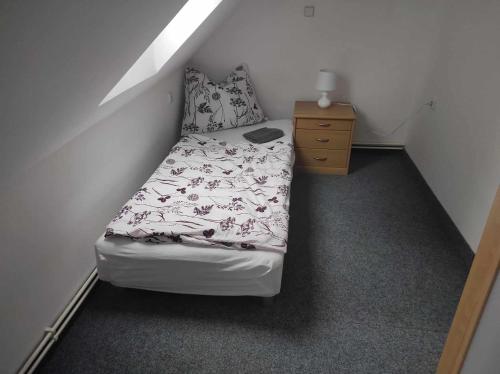 a small bedroom with a bed and a dresser at Apartmán Dobrá mysl in Hostinné