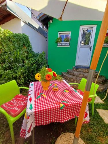 a table and chairs with a red and white checkered table cloth at Sweet Home in Valjevo