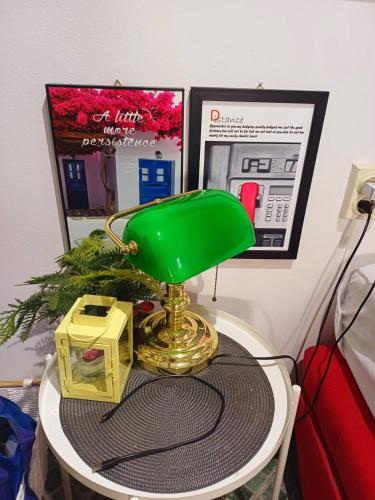 a green lamp sitting on top of a table at Sweet Home in Valjevo