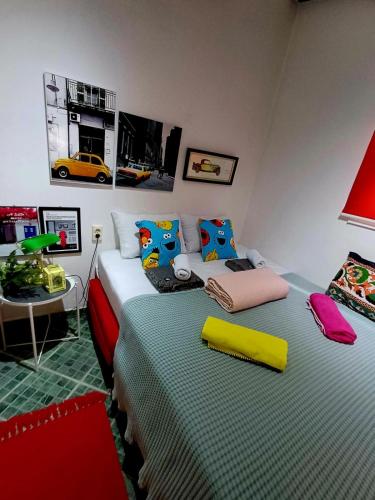 a bedroom with two beds with colorful pillows at Sweet Home in Valjevo