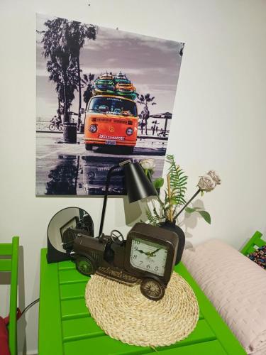 a table with a tv and a clock on top of it at Sweet Home in Valjevo