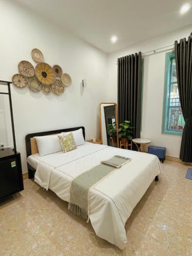 a bedroom with a large bed in a room at Under the Sun Homestay in Hue