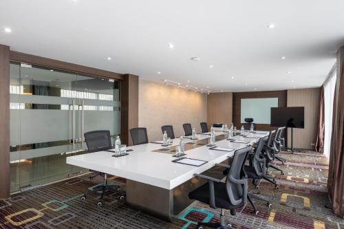 a conference room with a long table and chairs at Siam Mandarina Hotel - Free BKK Airport Shuttle in Lat Krabang