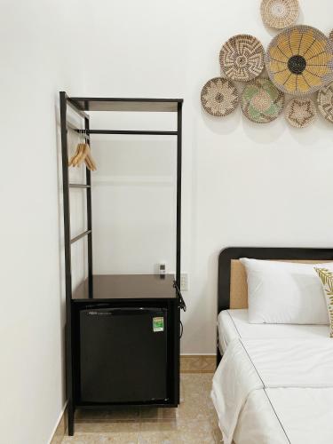 a bedroom with a mirror next to a bed at Under the Sun Homestay in Hue