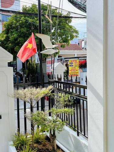 a balcony with a black fence and a flag at Under the Sun Homestay in Hue