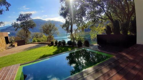 a swimming pool in the backyard of a house at Douro Suites in Riba Douro