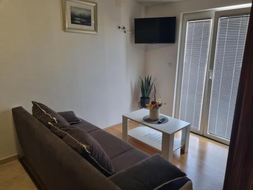 a living room with a couch and a table at Jurić Apartments in Biograd na Moru