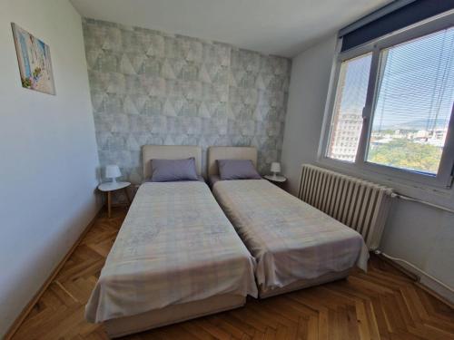 Postel nebo postele na pokoji v ubytování Niko-Max Apartment