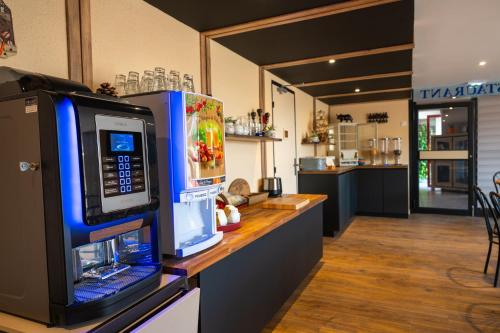 a kitchen with a counter with a microwave on it at Hôtel L'Etoile Aéroport - A61 in Carcassonne