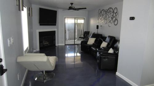a living room with black leather furniture and a fireplace at Modern/Retro Condo in High Point