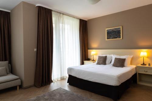 a hotel room with a bed and a window at St. George Hotel in Sofia