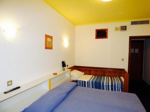 a bedroom with a bed and a desk in it at Mon Repos in Lido di Jesolo