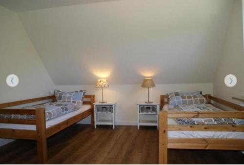 a bedroom with two beds and two night stands at Ferienwohnung-Auszeit in Hürup