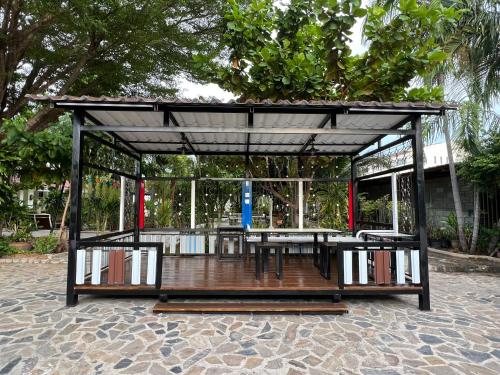 a pavilion with tables and chairs on a patio at Suanpai Resort Sattahip in Sattahip