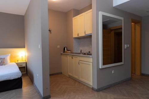 a small room with a bed and a kitchen at St. George Hotel in Sofia