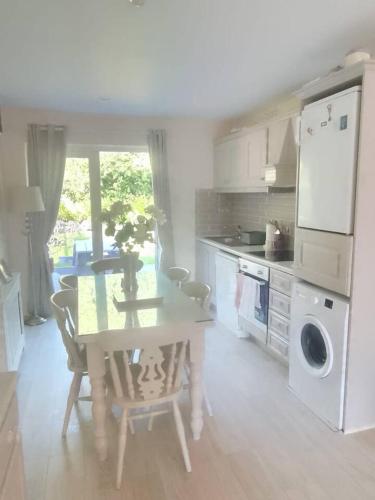 a kitchen with a table and a table and chairs at Kilarney cottage in Killarney