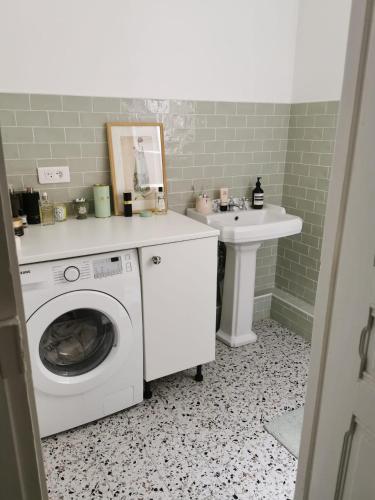 a bathroom with a washing machine and a sink at Home sweet home in Paris