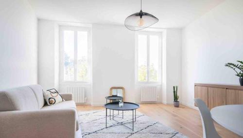 a living room with a couch and a table at Appartement neuf • Cosy et Lumineux • 4 personnes in Marseille