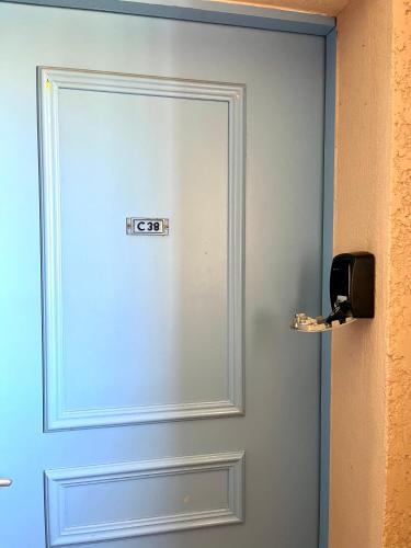 a door with a sign on it next to a wall at loumax in Gassin