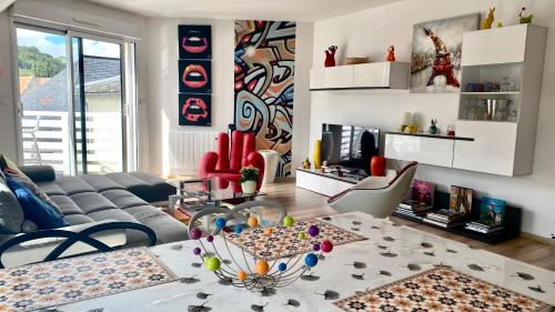 a living room with a couch and a table at La Seine en couleurs in Duclair