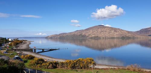 a view of a lake with a pier and a mountain at Tigh na Camus in Glenelg