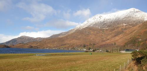 a snow covered mountain next to a body of water at Tigh na Camus in Glenelg