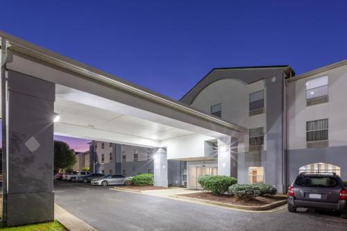 a car parked in a parking lot in front of a building at Super 8 by Wyndham La Grange KY in La Grange