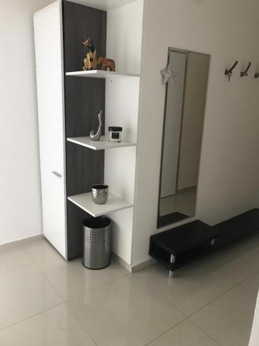 a bathroom with white shelves and a mirror at Ubytování U Kapličky in Olomouc