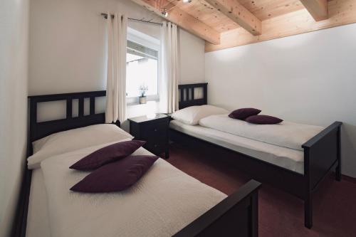 two beds sitting in a room with a window at Ferienhaus Kapeller in Sankt Jakob in Haus