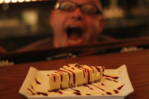 a person with an open mouth with a plate of food at Gingerbread Restaurant & Hotel in Nuevo Arenal