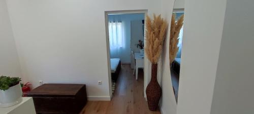 a hallway with a room with a table and two vases at Apartman Vlatka in Kninsko Polje