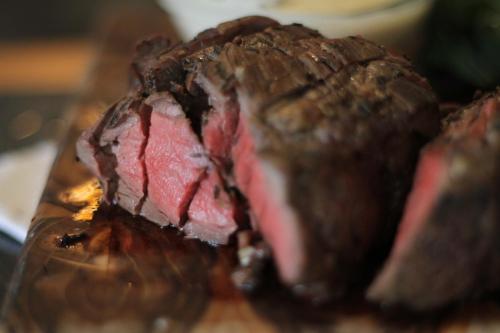 a close up of a piece of meat on a table at Gingerbread Restaurant & Hotel in Nuevo Arenal