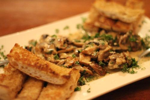 a plate of food with bread and mushrooms on it at Gingerbread Restaurant & Hotel in Nuevo Arenal