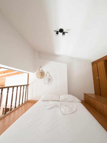 a bedroom with a white bed with a ceiling at Villa Aelia Kefalos-Private & Spacious with Pool in Kámpos
