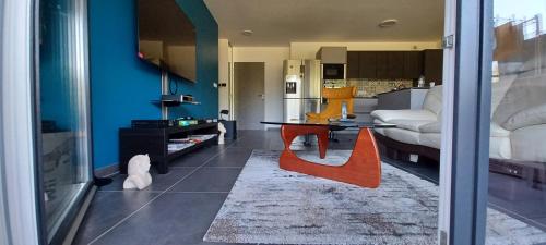 un salon avec une table et une chambre dans l'établissement Au 237, Le Nyong-Et-Sanaga, à Epagny Metz-Tessy