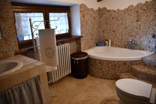 a bathroom with a tub and a toilet and a sink at Villa Anna in Rocca di Papa