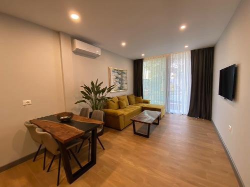 a living room with a couch and a table at Rosemarine Villas in Durrës