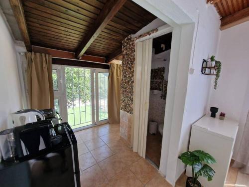 a hallway with a door to a room with a window at Elmy houses v3 / Clio in Rafina