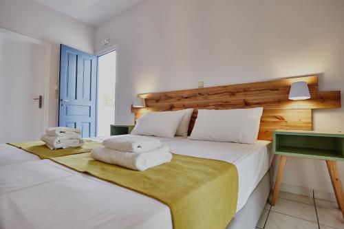 a bedroom with a bed with towels on it at Irene Studios in Agios Petros