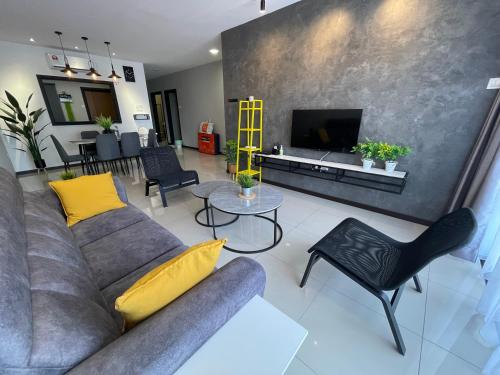 a living room with a couch and a tv at Ipoh Waterpark Manhattan Premium Suites by IWH Suites in Ipoh