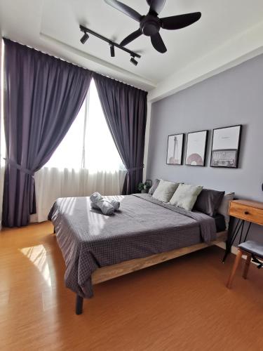 a bedroom with a bed and a ceiling fan at Harmonee Homes at The Hub SS2, PJ in Petaling Jaya