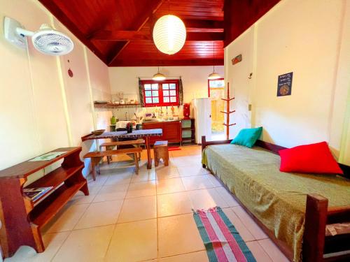a living room with a bed and a dining room at Condomínio Aldeia in Abraão